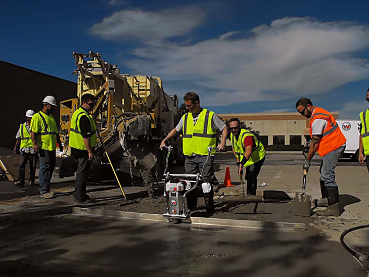 several men working on wet concrete